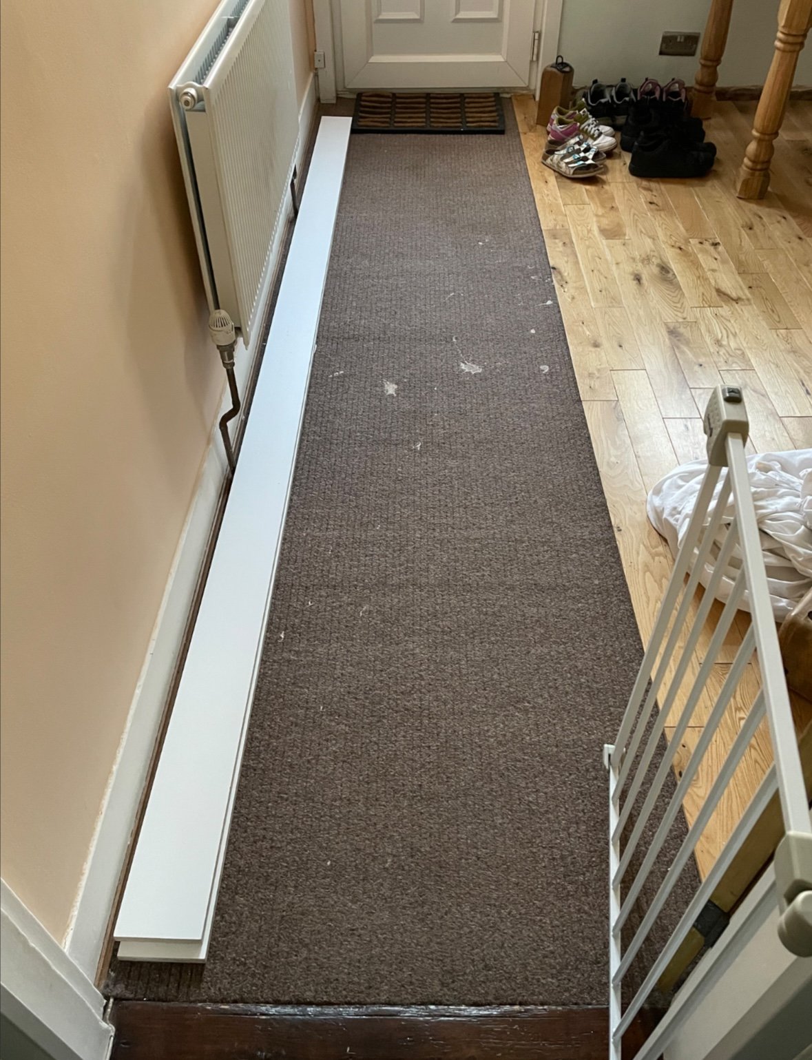 Couloir avec moquette marron usée - avant